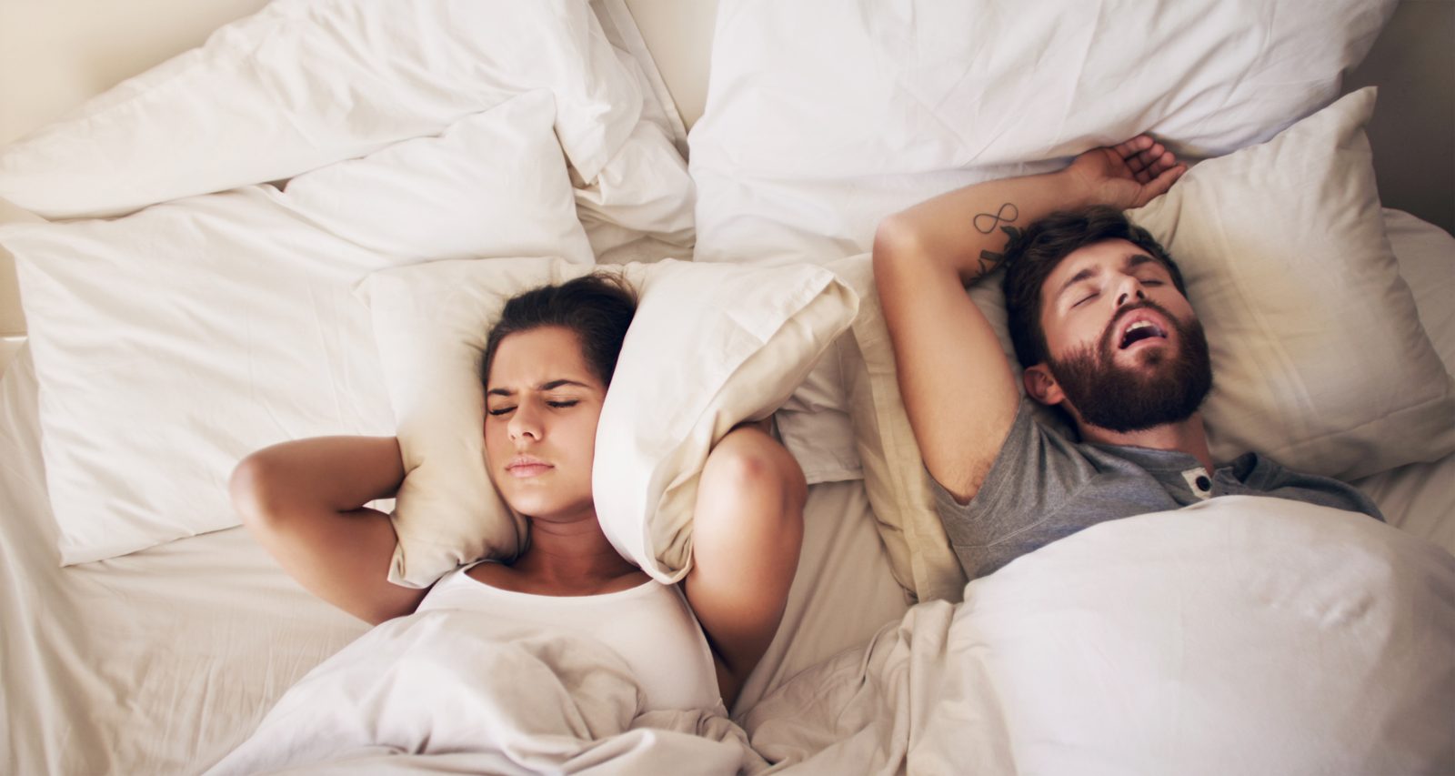 Calm, rested couple in a sunlit bedroom, illustrating better sleep after sleep apnea care